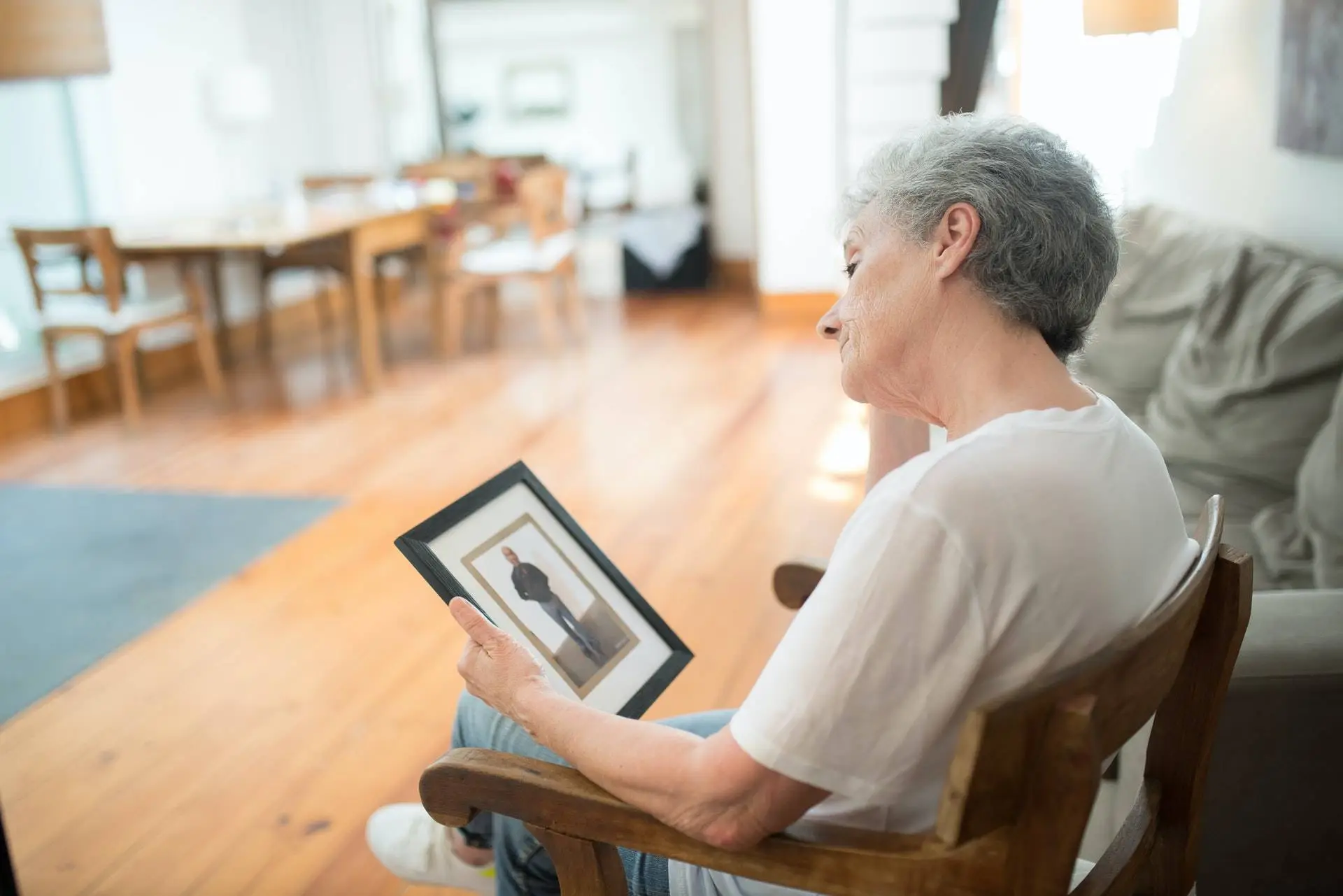 A Man sitting on easy chair and looking Missing person, portfolio private detective agency in Selaqui